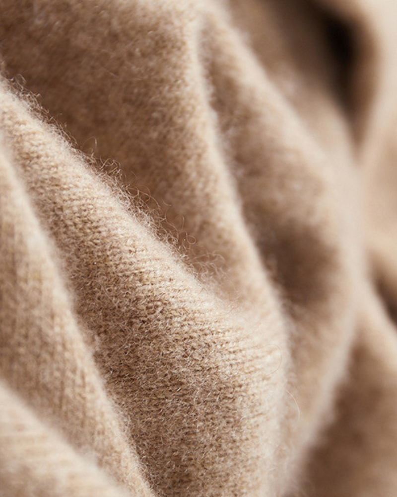 Macro detail of soft camel cashmere knit texture with fine brushed fibres