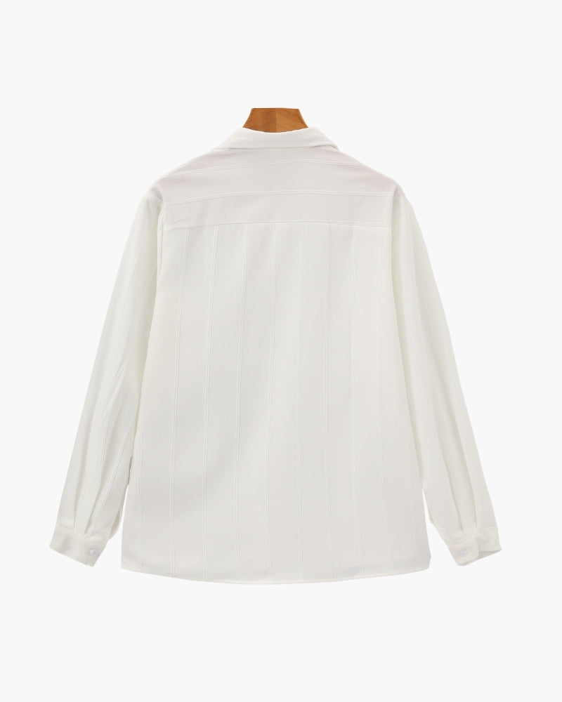 White vertical-rib long-sleeve shirt on a wooden hanger, flat back view