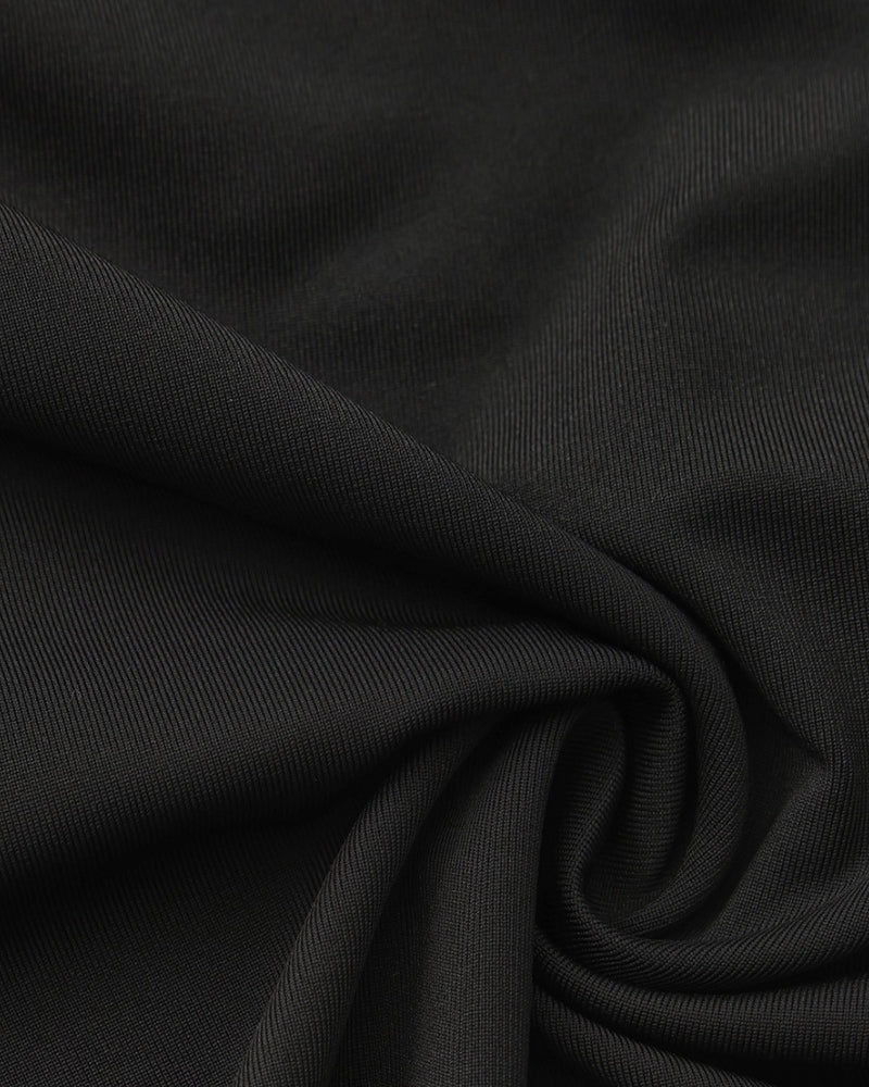 Close-up of black stretch jersey fabric folded in soft swirls