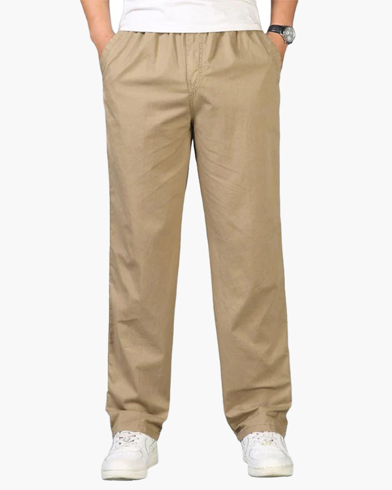Man in khaki straight cotton-linen trousers with elastic waist, white tee and trainers