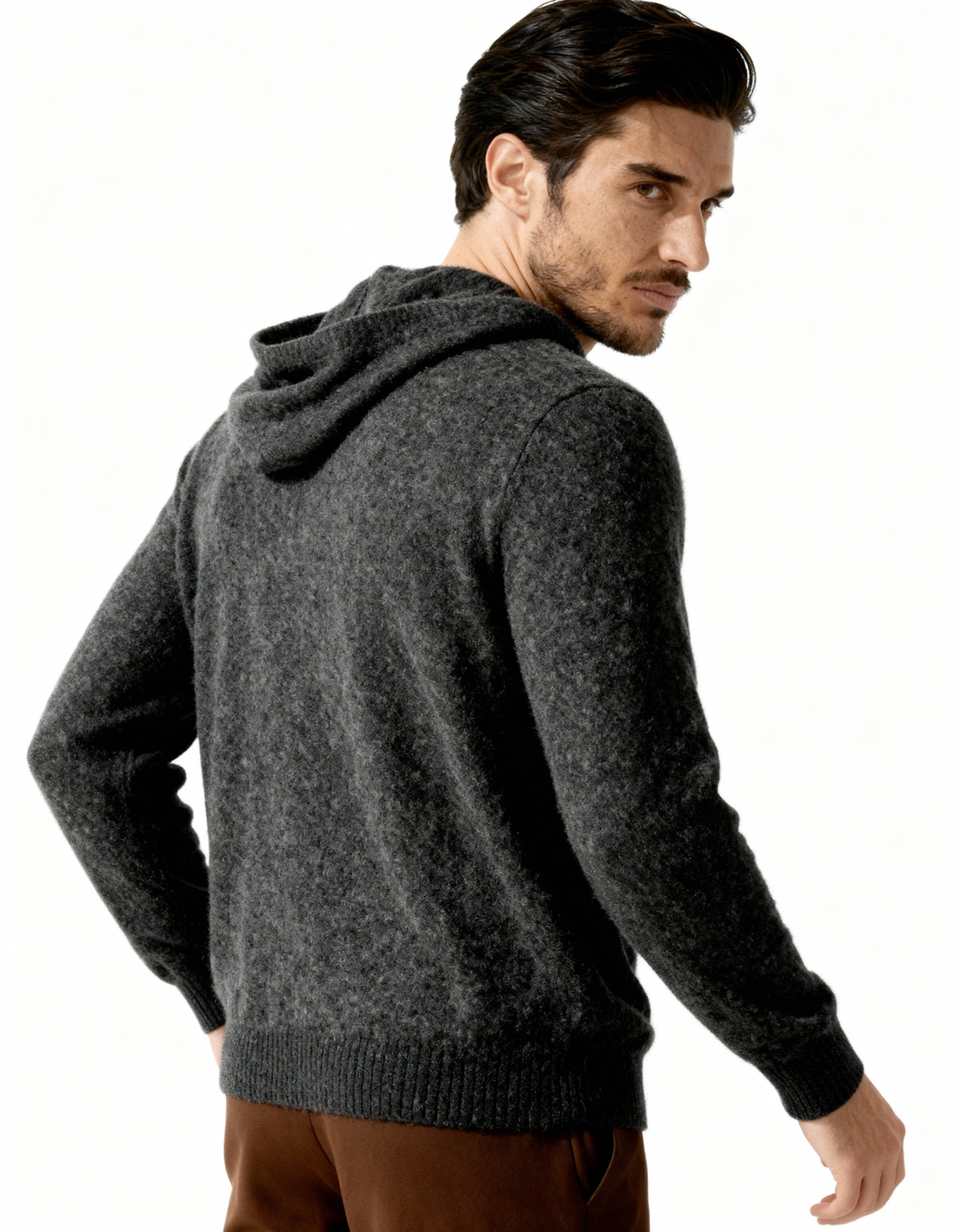 Back and side view of a dark grey cashmere hoodie showing the hood and ribbed hem, on model