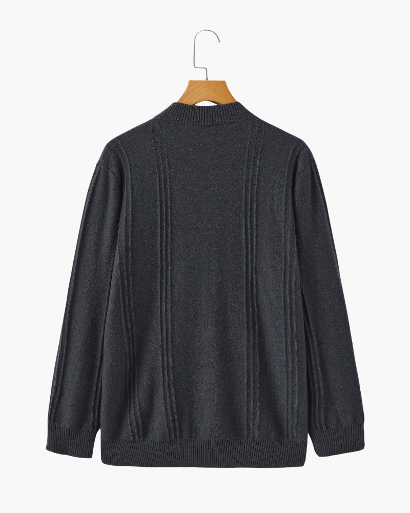 Back of a charcoal cashmere half-zip jumper on a hanger, plain with ribbed hem