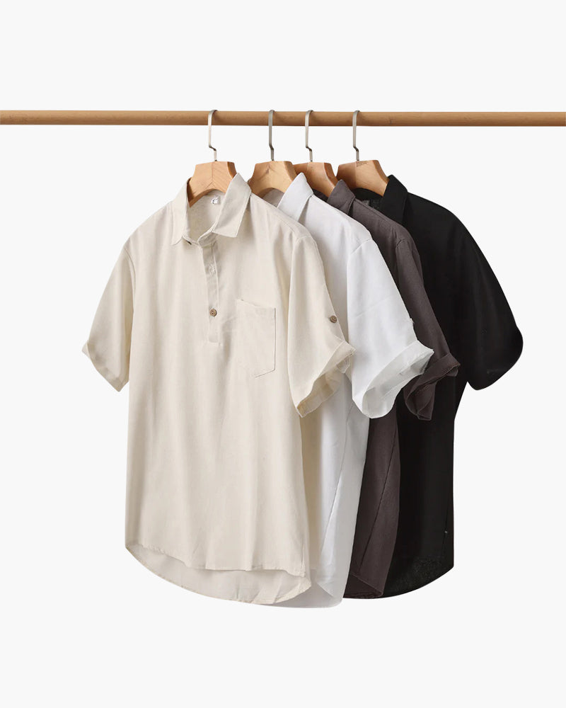 Rail of short-sleeve linen polo shirts in cream, white, taupe and black on hangers