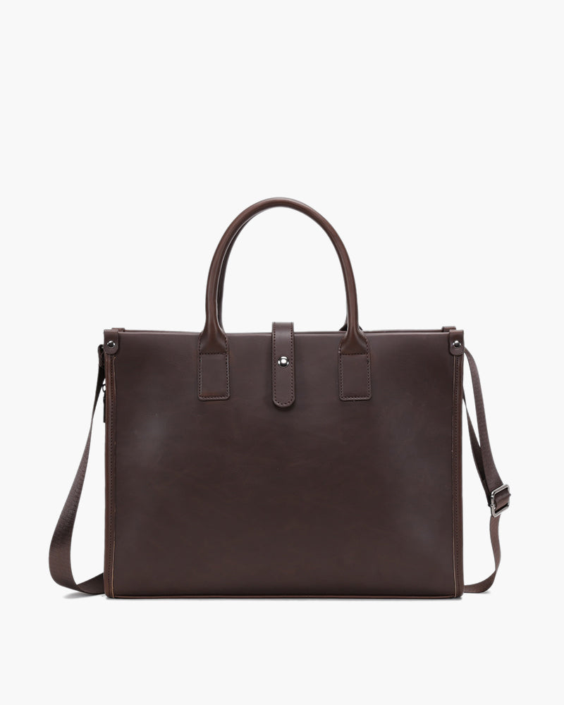 Dark brown leather laptop briefcase with twin top handles, flap tab and shoulder strap, front view