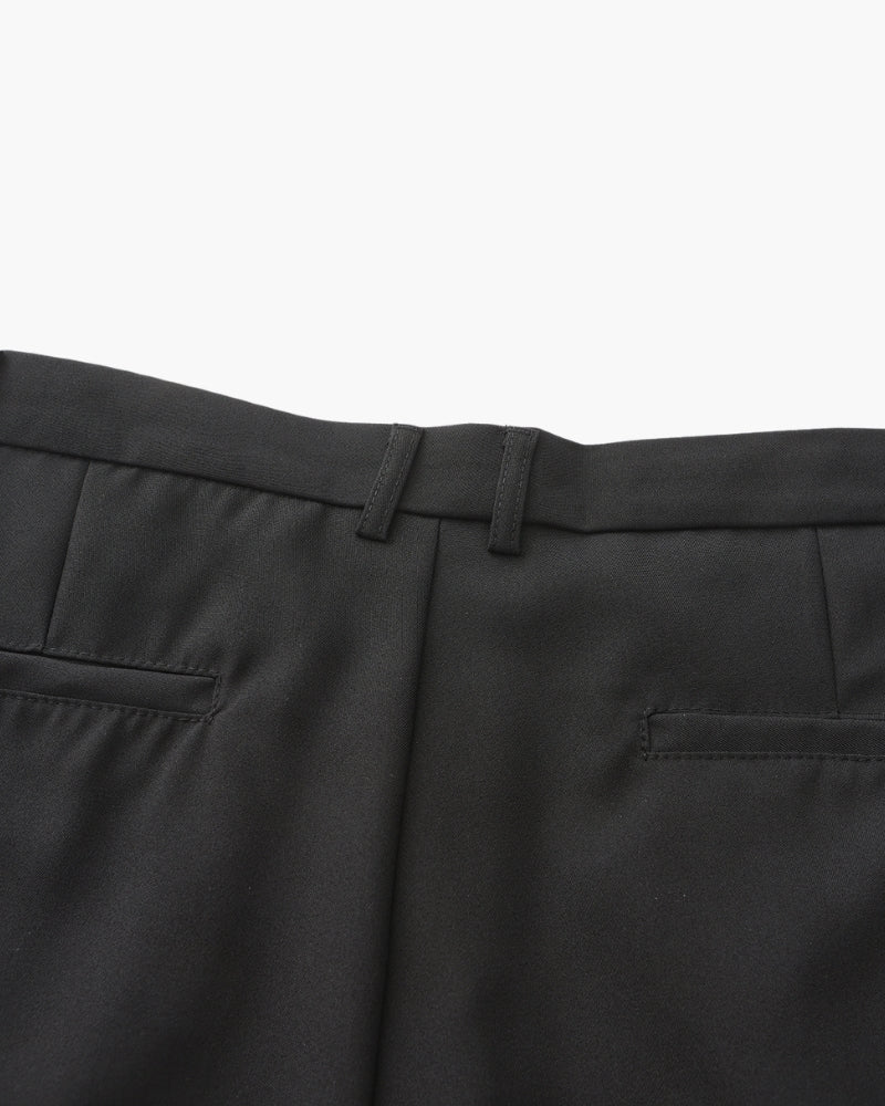 Close-up of black trousers back waistband with welt pockets – Men's Wide-Fit Trousers