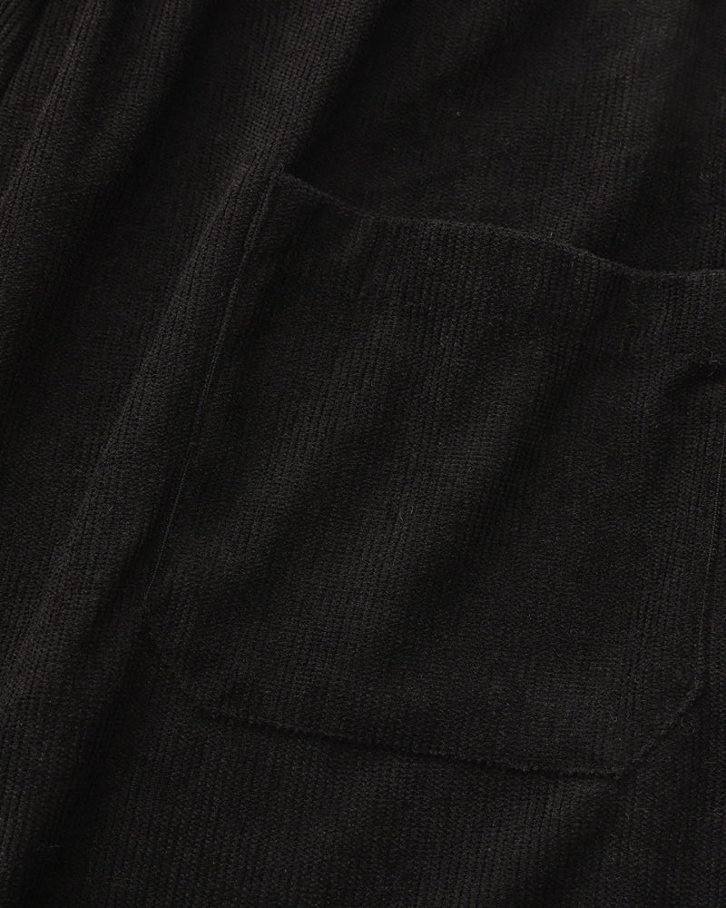 Close-up of black textured shirt chest pocket and fabric, detail shot