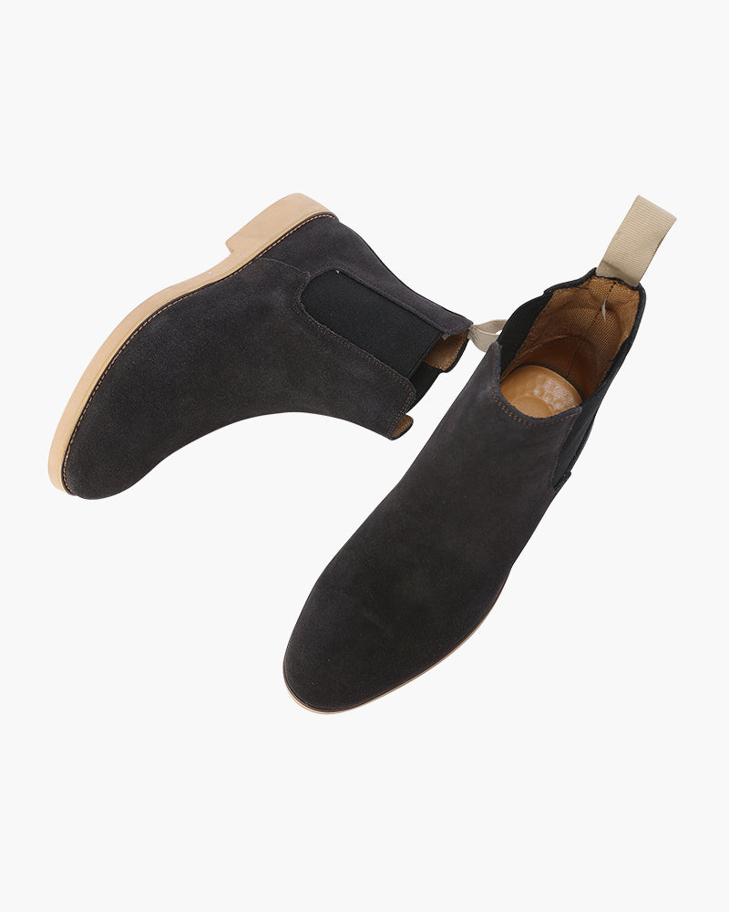 Pair of charcoal suede Chelsea boots seen from above showing tan lining