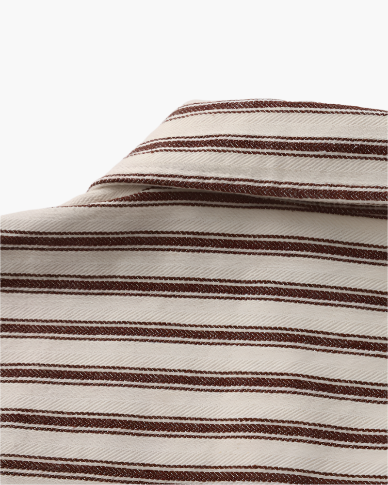 Close-up of striped shirt point collar in brown and cream twill