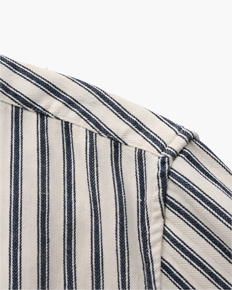 Close-up of navy and cream striped shirt shoulder seam and collar