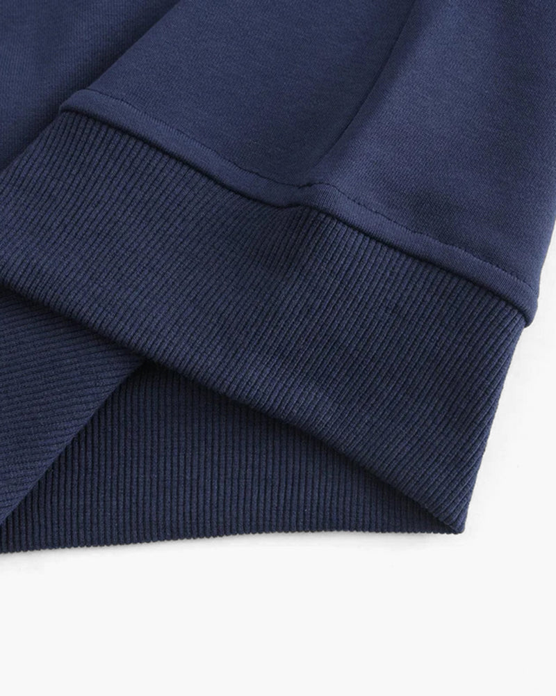 Close-up of navy sweatshirt ribbed cuff and hem with flat stitched seam