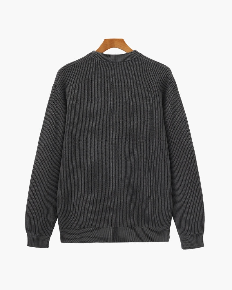 Back view of charcoal-grey washed chunky rib-knit crew-neck jumper on a wooden hanger