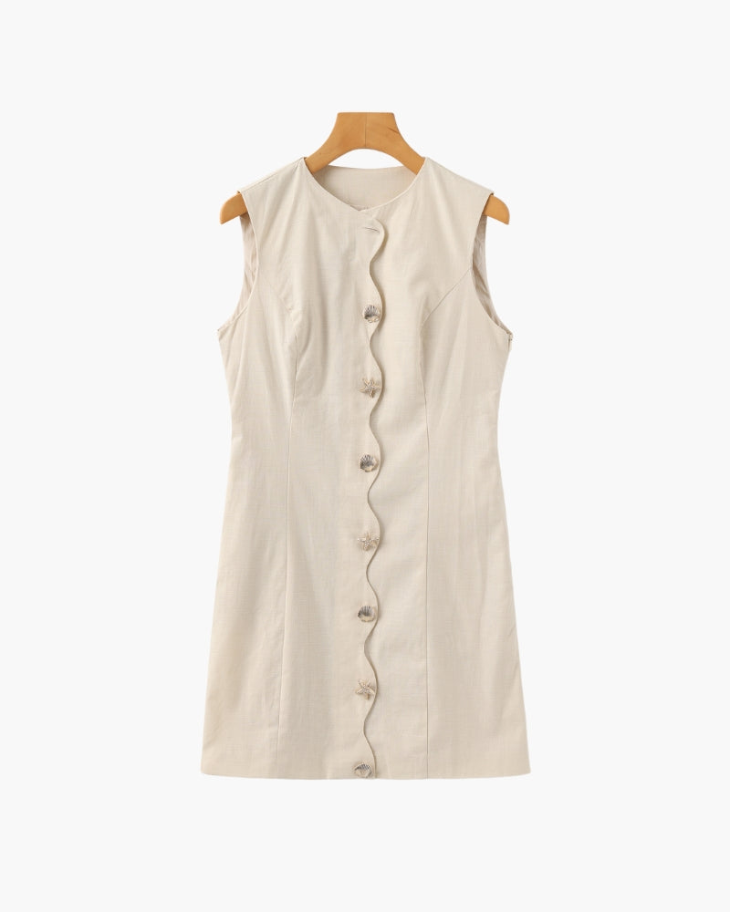 Cream sleeveless mini dress with scalloped button placket on a wooden hanger, flat front view