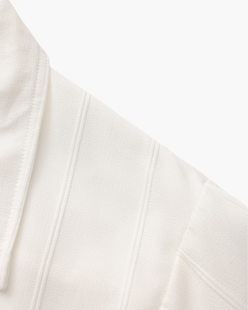 Close-up of white ribbed shirt collar seam and raised vertical stripes