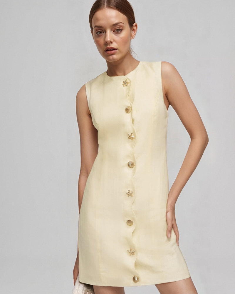 Pale yellow sleeveless mini dress with a wavy button placket, worn by a model, front view