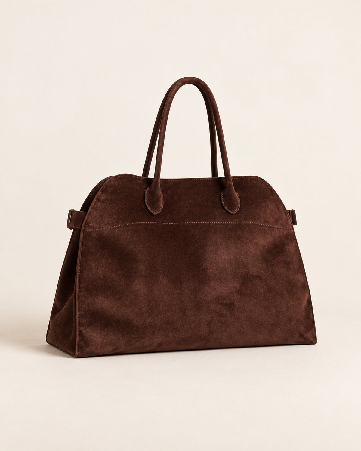 Dark brown suede-look arched handbag with two rolled handles, angled three-quarter view